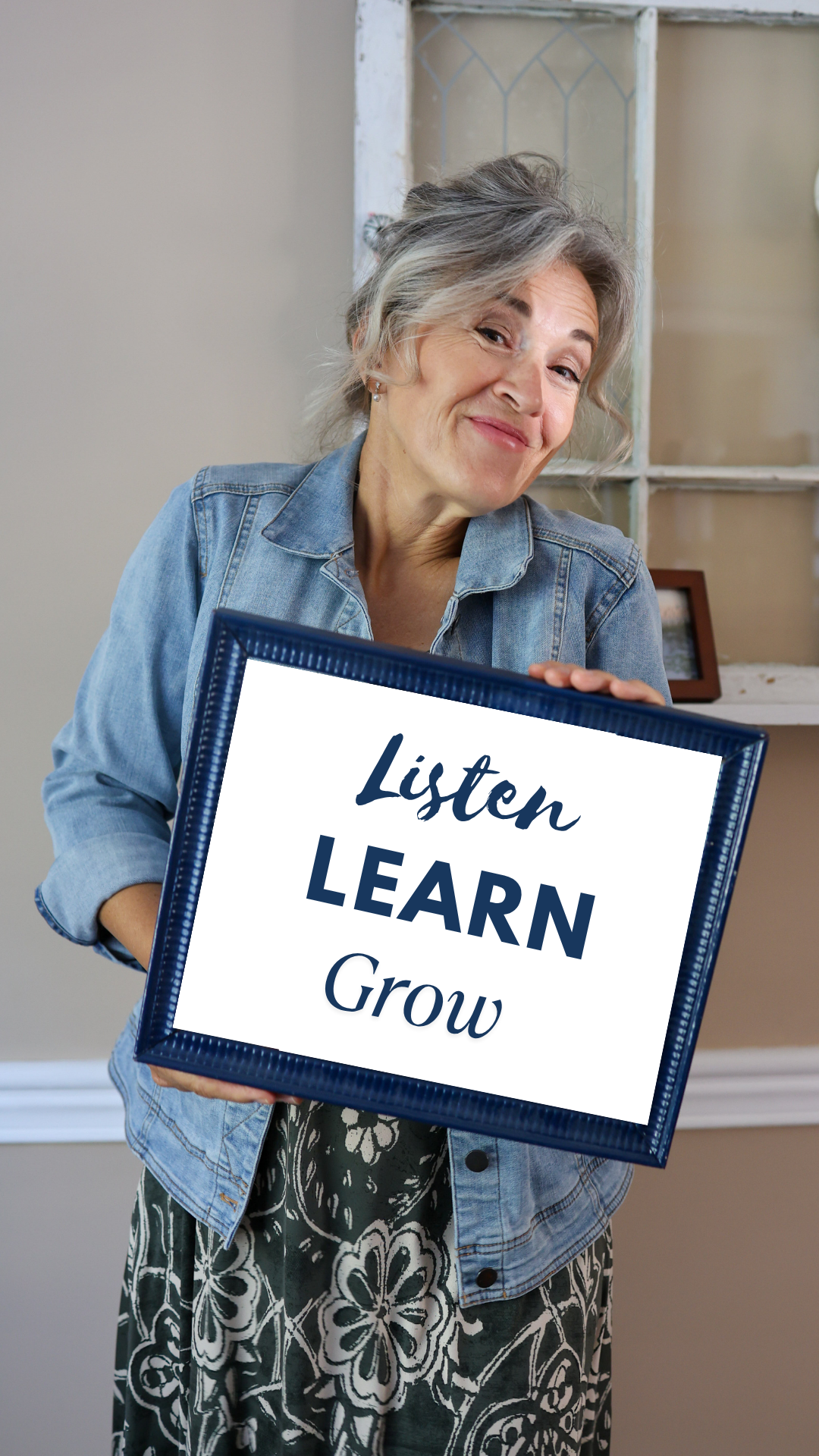 Victoria holding a sign that says Listen, Learn, Grow